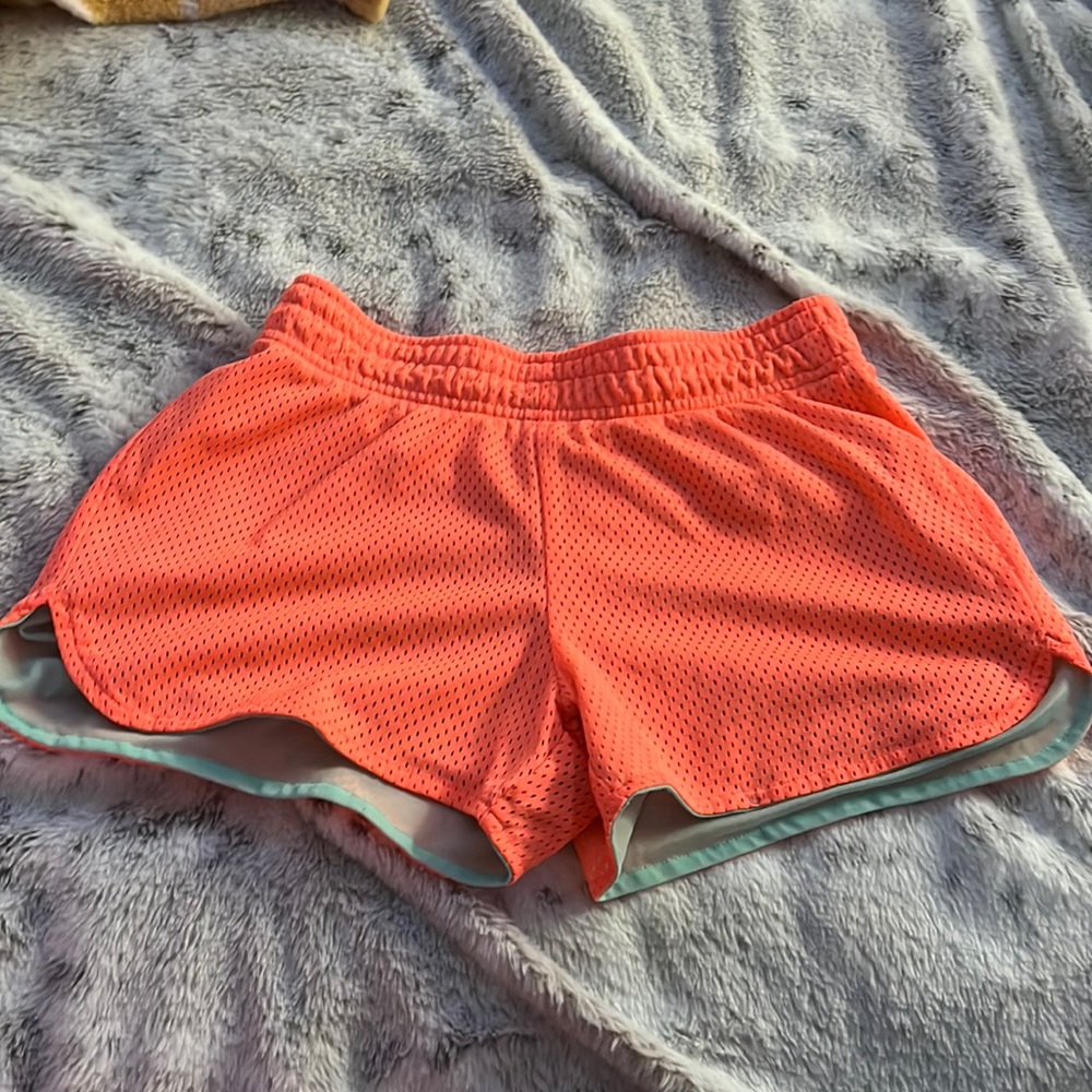 neon peachy orange, inside lining is light teal, bcg, running shorts